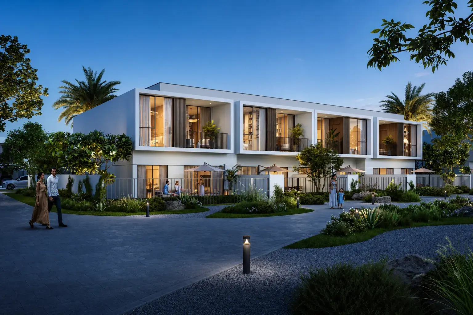 Alva at The Valley by Emaar, contemporary townhouses at twilight with warm interior lighting